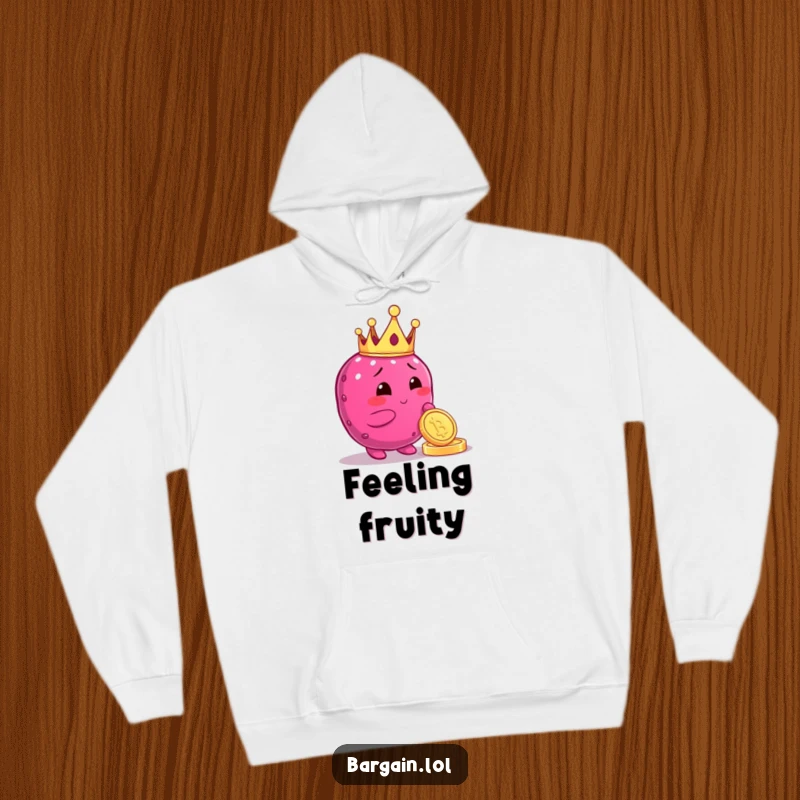 Funny hoodie featuring a plump berry character in a tiny crown, admiring a shiny coin, offering cozy comfort and a regal vibe.