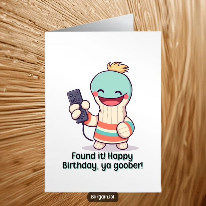 Funny Free Printable Birthday Card: Grinning sock puppet proudly displays a lost TV remote, ready for celebration.